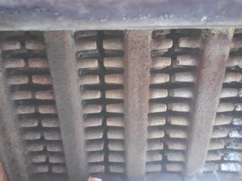 Performed scheduled boiler maintenance including inspection of heat exchanger coils which showed normal dust accumulation but no significant deterioration. Replaced corroded anchor bolts in two rows (4 upper, 5 lower) that were showing substantial rust and wear.