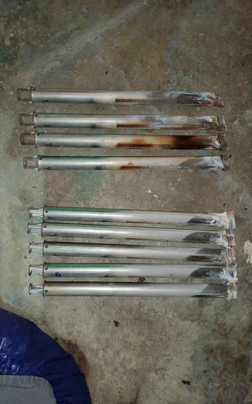 Performed scheduled boiler maintenance including inspection of heat exchanger coils which showed normal dust accumulation but no significant deterioration. Replaced corroded anchor bolts in two rows (4 upper, 5 lower) that were showing substantial rust and wear.