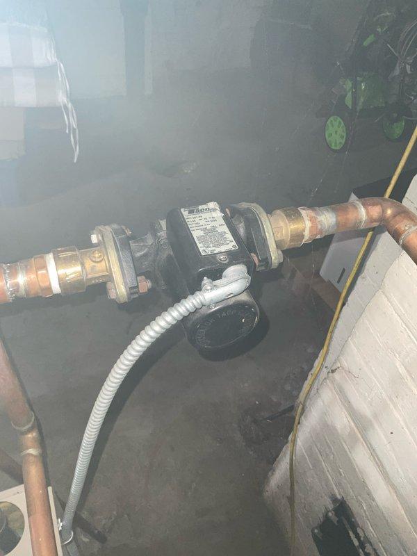 Performed scheduled annual maintenance on 21-year-old hot water boiler system. Inspected circulation pump, verified proper electrical connections and pump operation. Examined copper piping system, checked all brass fittings and flanges for leaks, and tested pressure regulator valve functionality. System is operating within normal parameters.