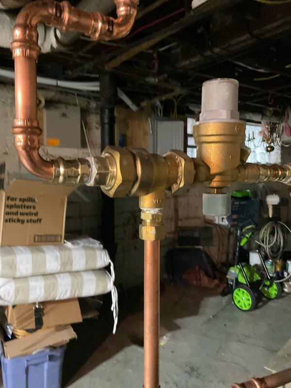 Performed scheduled annual maintenance on 21-year-old hot water boiler system. Inspected circulation pump, verified proper electrical connections and pump operation. Examined copper piping system, checked all brass fittings and flanges for leaks, and tested pressure regulator valve functionality. System is operating within normal parameters.