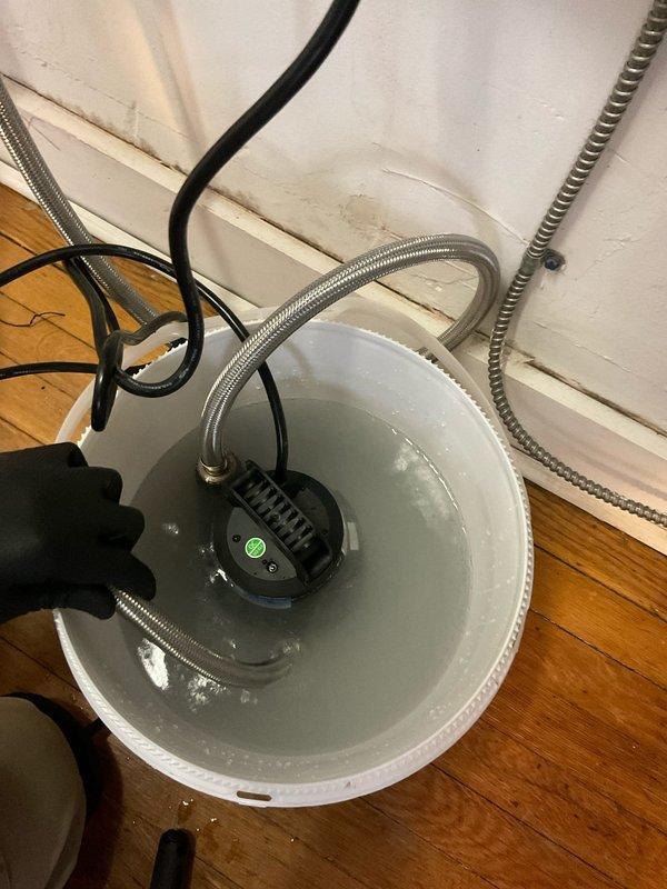 Performed scheduled tankless water heater descaling service. Removed and cleaned filter screen of accumulated debris. Connected flush pump to unit and circulated descaling solution through heat exchanger to remove mineral buildup, restoring optimal performance and efficiency.