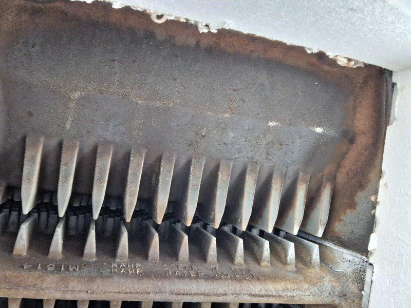 Performed scheduled Heating Tune Up under Home Plan on boiler system. Identified significant corrosion and rust on heat exchanger fins with substantial dust/debris accumulation between fins. Observed deterioration of metal components and compromised insulation/sealant at connection points requiring attention for optimal system performance.