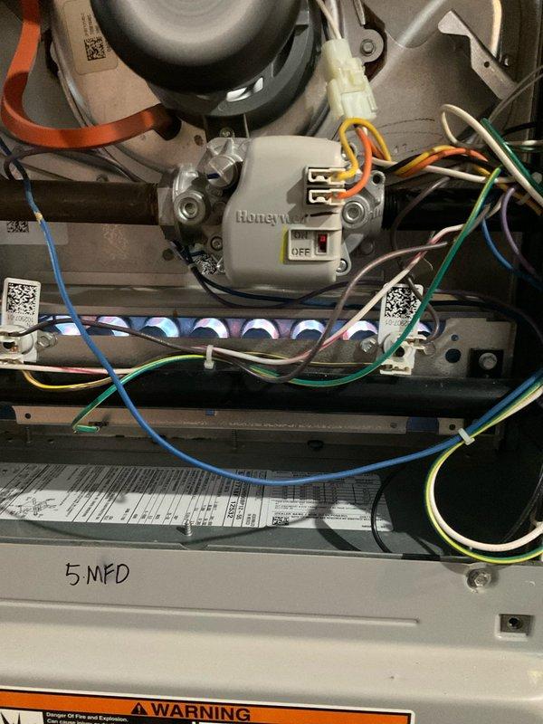 Performed scheduled maintenance on 4-year-old furnace utilizing manufacturer-recommended tune-up procedures. Inspected Honeywell control module, verified proper wiring connections to all components, and checked system operation. Also examined adjacent Rheem Performance water heater installation for proper venting and connection integrity.