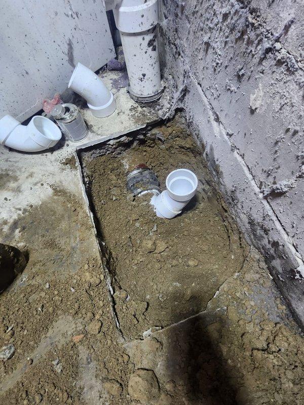 Completed replacement of single bowl plastic tub installation following removal of existing cement tub. Work involved excavation of concrete foundation area to access and replace plumbing connections, with installation of new PVC drainage pipes and fittings throughout the system. Parts have been ordered with installation team scheduled to return for completion once components arrive from warehouse.