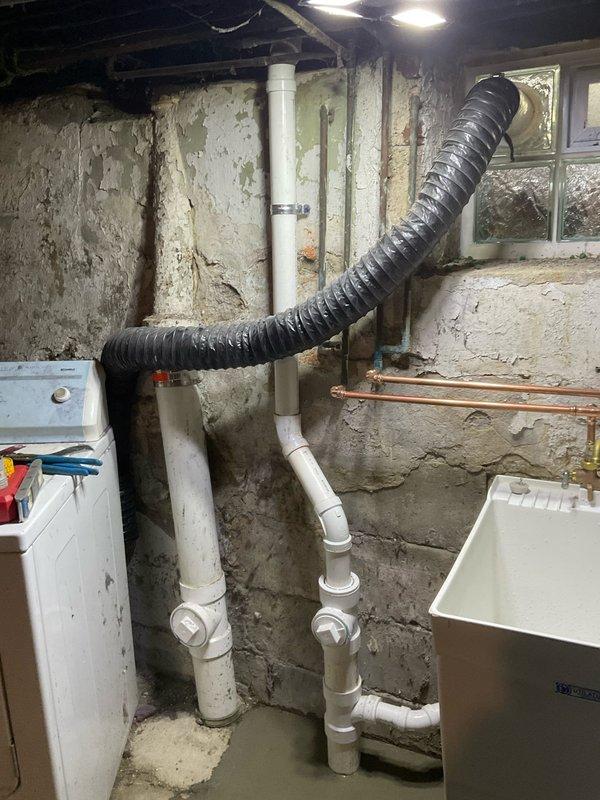 Completed replacement of single bowl plastic tub installation following removal of existing cement tub. Work involved excavation of concrete foundation area to access and replace plumbing connections, with installation of new PVC drainage pipes and fittings throughout the system. Parts have been ordered with installation team scheduled to return for completion once components arrive from warehouse.