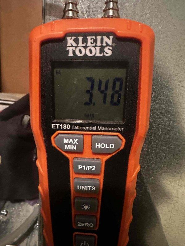Successfully installed complete HVAC system including new furnace with high airflow base, coil, condenser, and thermostat while integrating existing air cleaner, humidifier, and refrigerant lines. System was properly connected to existing 2" PVC venting and verified operational with pressure testing showing 3.48 inH₂O on manometer measurement.