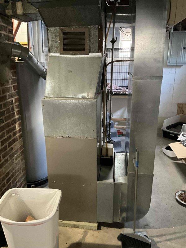 Conducted comprehensive evaluation of 24-year-old furnace and AC system in basement utility area. Inspection revealed aging equipment with standard galvanized ductwork configuration running through exposed joists. Replacement estimate provided for complete HVAC system upgrade to address equipment age and improve efficiency.