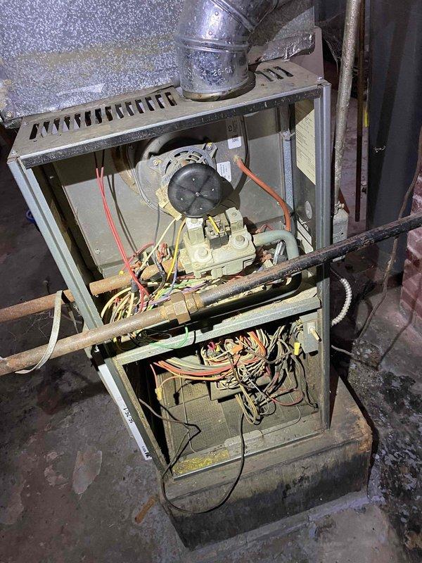 Responded to service call for an older gas furnace that would not light. Upon inspection, found significant dust accumulation throughout the system and noted the furnace was venting into a brick chimney structure showing signs of deterioration. Cleaned critical components and restored proper ignition sequence, enabling normal heating operation.