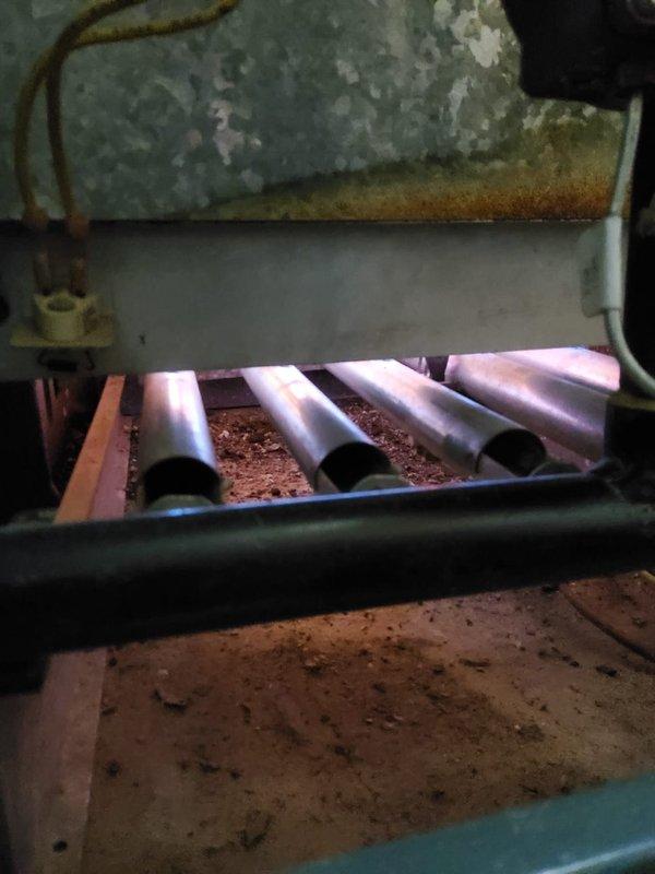 Performed diagnostic service on Weil-McLain hydronic boiler system to address radiator leakage and knocking sounds. Inspection revealed significant corrosion and mineral deposits on the boiler's upper housing and heat exchanger assembly. Documented extensive dust accumulation and wear on the heat exchanger fins, indicating system requires thorough cleaning and possible component replacement to restore proper operation.