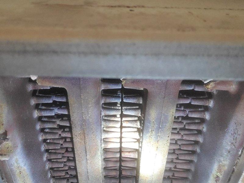 Performed scheduled maintenance on steam boiler system. Inspected heat exchanger fins which showed signs of discoloration and minor corrosion buildup. Verified proper burner operation with good flame pattern and color indicating efficient combustion.