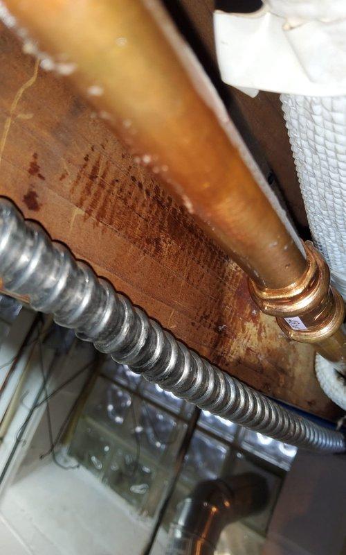 Performed scheduled preventative maintenance on mini-split heating system. Inspected copper refrigerant lines and electrical connections, noting minor condensation on copper line. Verified proper installation of insulated refrigerant line secured to joists with appropriate fasteners alongside electrical conduit.