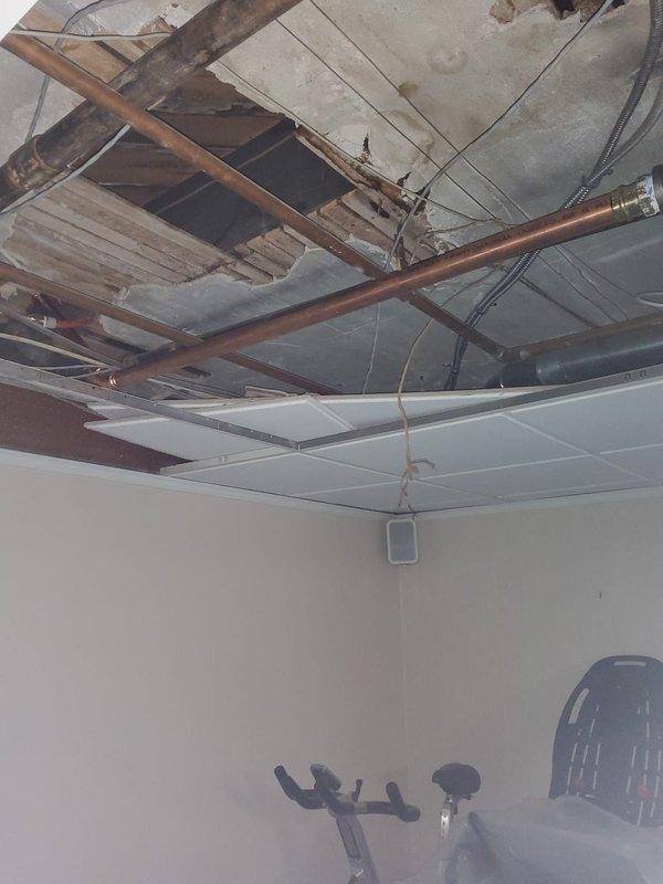 Completed initial phase of multi-stage steam radiator relocation project, removing and preparing to reinstall two radiators from 2nd floor bedroom and 3rd floor bathroom to adjacent rooms. Accessed and evaluated concealed steam line in wall between dining room and kitchen, requiring further assessment once demolition is complete. Relocated cooling thermostat in dining room to adjacent wall and documented exposed subfloor structure and ceiling cavity to prepare for subsequent pipe modifications.