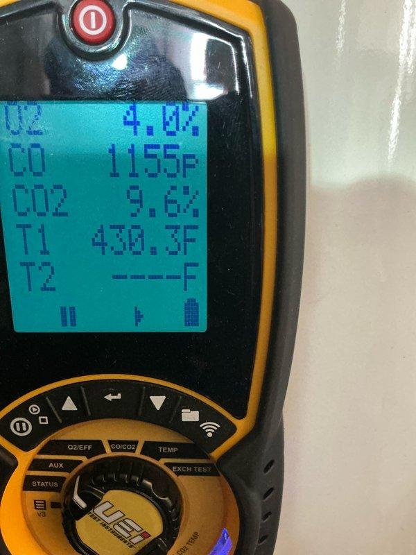 Performed comprehensive boiler tune-up service with combustion analysis. Conducted efficiency testing using digital analyzer, measuring O2 (4.0%), CO (1155P), CO2 (9.6%), and stack temperature (430.3°F). Secondary readings confirmed ambient temperature at 27.0°F with T1 probe measuring 136.2°F. Completed all manufacturer-recommended maintenance procedures.