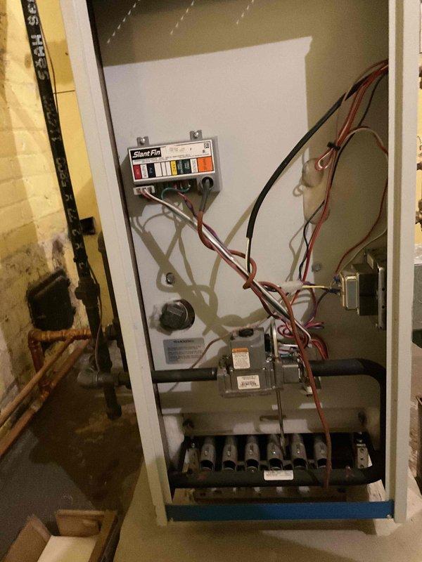 Performed tune-up maintenance service on two heating systems: a furnace with Silent Pilot control board and a boiler system with associated plumbing. Visual inspection of both units confirmed proper installation of components including wiring, gas valve assembly, heat exchanger, pressure gauge, and various piping connections.