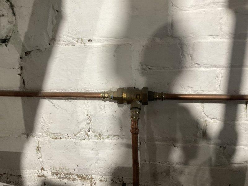 Performed scheduled maintenance on 8-year-old MVP steam boiler system. Inspected copper piping and T-junction valve assembly for proper operation. Evaluated main boiler unit, checked control panels, and examined all connection points; placed collection buckets to capture minor condensation during service.