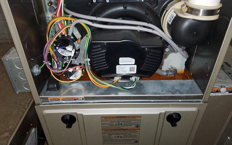 Diagnosed and repaired water leak on 3-year-old furnace by identifying condensate drain line blockage in the secondary drain pan beneath the evaporator coil. Cleared obstruction, verified proper drainage function, and confirmed normal system operation with no further moisture accumulation.