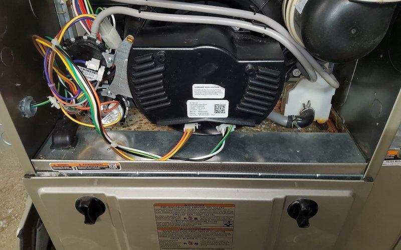 Diagnosed and repaired water leak on 3-year-old furnace by identifying condensate drain line blockage in the secondary drain pan beneath the evaporator coil. Cleared obstruction, verified proper drainage function, and confirmed normal system operation with no further moisture accumulation.