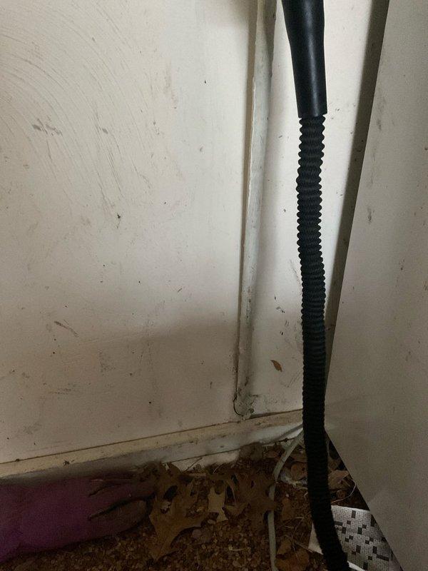 Replaced deteriorated valve in 70-year-old home's basement water pipe system where significant wall penetration damage was evident. Installed new black flexible supply line to replace existing compromised plumbing, ensuring proper sealing at the wall junction to prevent future water damage and structural deterioration.