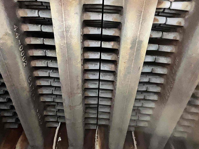 Completed Home Plan Heating Tune Up service on a gas furnace system. Inspected burner assembly showing proper blue-to-orange flame pattern indicating efficient combustion, though minor sooting was observed on upper portions of burner tubes. Examined heat exchanger which displayed normal aging with some dust accumulation but remains in functional condition with no significant corrosion or damage detected.