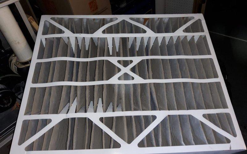 Performed Home Plan Heating Tune Up on residential HVAC system. Inspected and replaced pleated air filter which showed moderate dust accumulation. Conducted visual inspection of furnace unit and surrounding ventilation components in basement utility area.