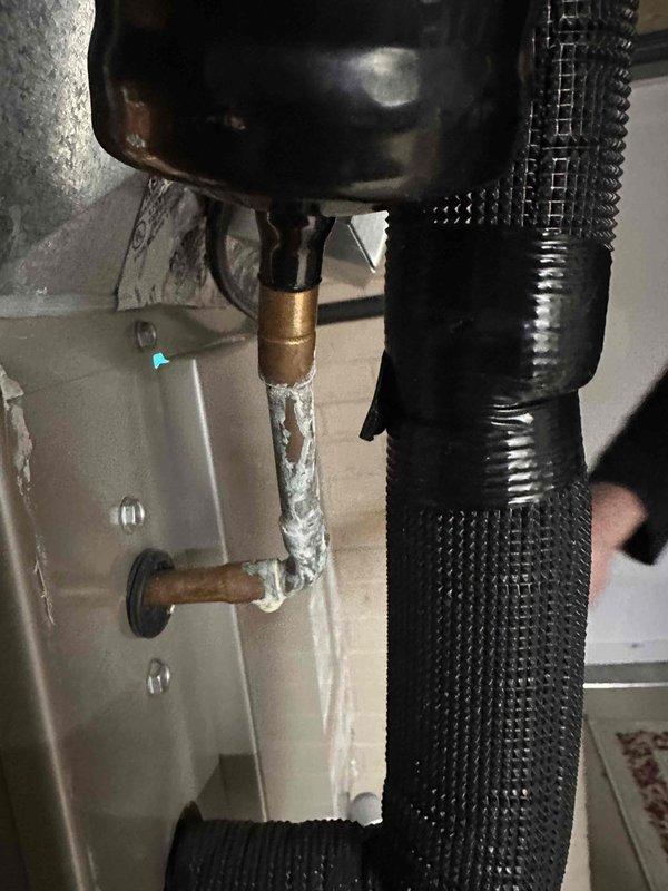 Performed routine maintenance on two natural gas furnace systems. Identified and documented active water leakage from copper pipe connection with brass fitting. Conducted gas pressure testing with dual port manometer, recording readings of 150/154.