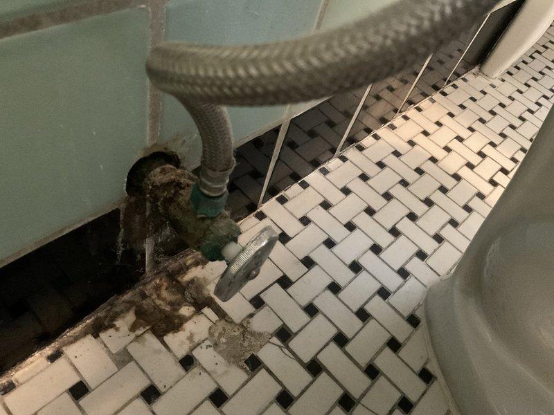 Responded to service call for a recurring toilet clog issue. Inspection revealed an aging toilet with significant deterioration around the supply line connection, showing water damage and mineral buildup. Customer elected to have the unit replaced rather than repaired due to its advanced age and condition.