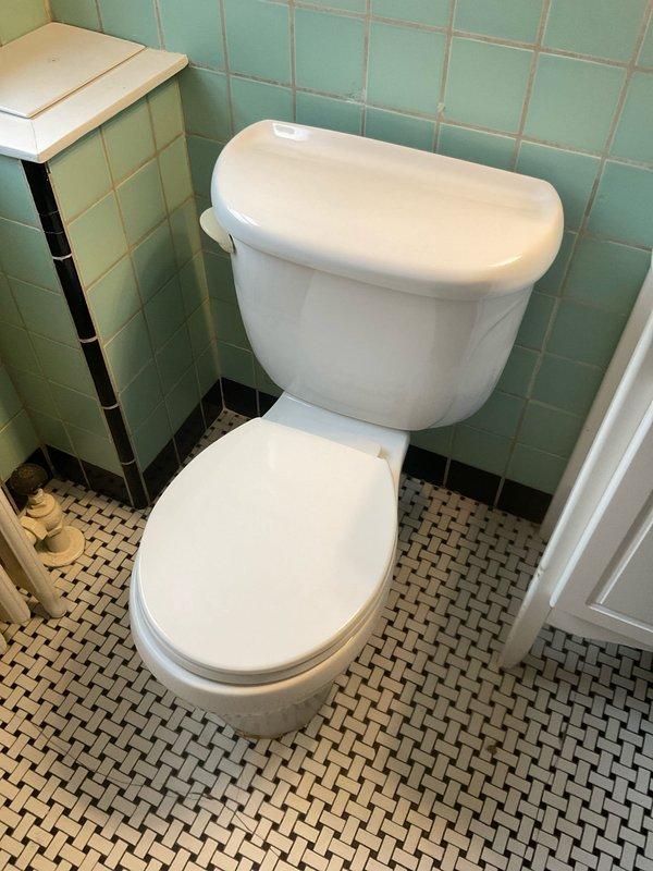 Responded to service call for a recurring toilet clog issue. Inspection revealed an aging toilet with significant deterioration around the supply line connection, showing water damage and mineral buildup. Customer elected to have the unit replaced rather than repaired due to its advanced age and condition.
