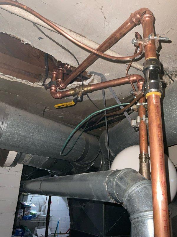 Replaced existing CPVC water piping with copper piping per code requirements. Installed expansion tank and performed proper bonding to ensure compliance with current plumbing regulations. Verified all connections were secure with no leaks present and system functioning properly after rework completion.
