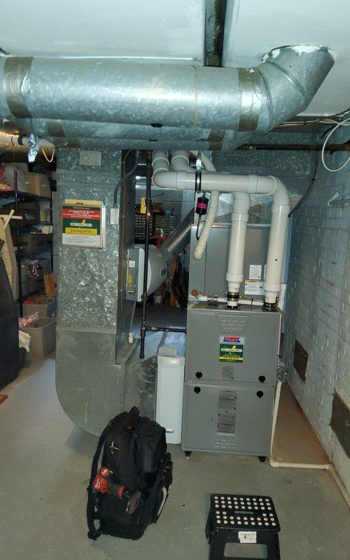 Performed scheduled maintenance on 6-year-old furnace under Home Plan Heating Tune Up service. Conducted combustion analysis using UEi C161 analyzer, which measured O2 at 12.3%, CO at 19P, CO2 at 4.9%, and stack temperature at 88.0°F. Inspected ductwork connections and condensate drain system, confirming proper installation with secure metal tape at joints.