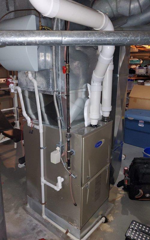 Performed annual maintenance on Carrier furnace system under Home Plan agreement. Inspected electrical connections at terminal block, noting minor corrosion on enclosure that does not currently affect operation. System is functioning properly with all ductwork, PVC venting, and condensate lines in good condition.