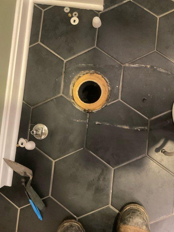 Responded to warranty callback for rocking toilet with water leakage. Removed toilet, replaced deteriorated wax ring seal, and reinstalled toilet securely to the flange. Confirmed proper seal and stability after installation with no further leakage observed.