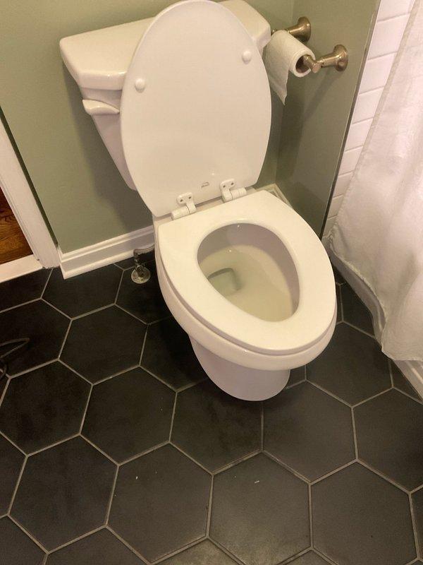 Responded to warranty callback for rocking toilet with water leakage. Removed toilet, replaced deteriorated wax ring seal, and reinstalled toilet securely to the flange. Confirmed proper seal and stability after installation with no further leakage observed.