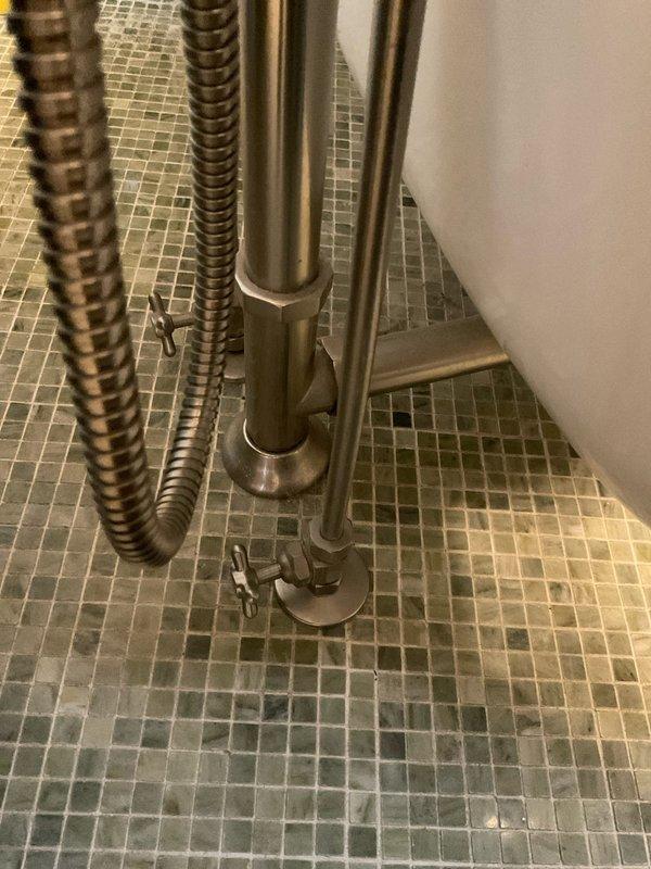 Diagnosed and repaired leaking TOTO toilet in 43-year-old residential bathroom by replacing deteriorated flapper valve and addressing mineral buildup in tank. Inspected supply line connections and floor mounting to ensure proper installation, eliminating leak and restoring proper flush functionality.