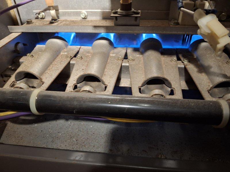 Responded to service call for 20-year-old furnace not operating properly. Inspection revealed dusty but functional burners with proper blue flame pattern. System was tested and confirmed to be operating within normal parameters; no immediate repairs needed at this time.