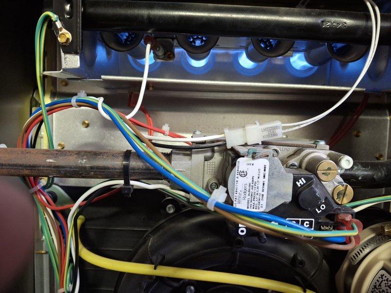 Performed annual maintenance on 3-year-old furnace under Home Plan Heating Tune Up service. Inspected burner assembly confirming proper flame pattern and color, and conducted combustion analysis using UEi diagnostic meter to verify optimal operating parameters. All electrical connections were checked and secured, and gas valve operation was verified with appropriate hi/lo settings functioning correctly.