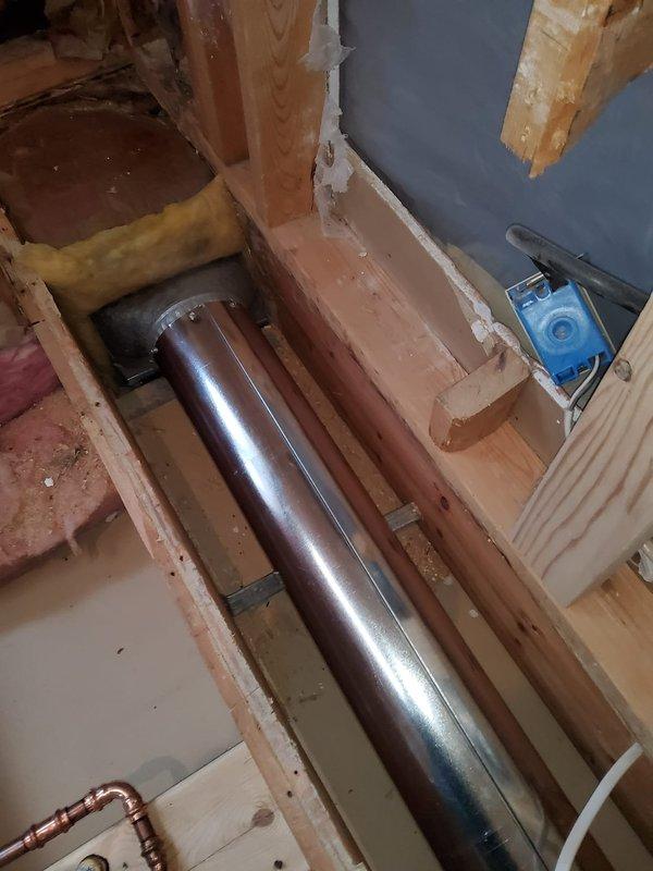 Successfully extended existing ductwork by installing 6" diameter pipes (24" and 60" sections) with a 4x10x6 left-hand center boot to redirect airflow along the wall. Completed installation with a 4x10 white floor register, ensuring proper integration with the existing HVAC system within the exposed framing structure.