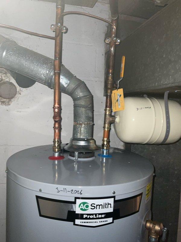 Successfully installed a new 40-gallon A.O. Smith ProLine water heater with expansion tank in utility area. Completed proper bonding of water lines per code requirements and connected all necessary hot/cold water connections with appropriate valves. System was tested and confirmed operational with proper venting.