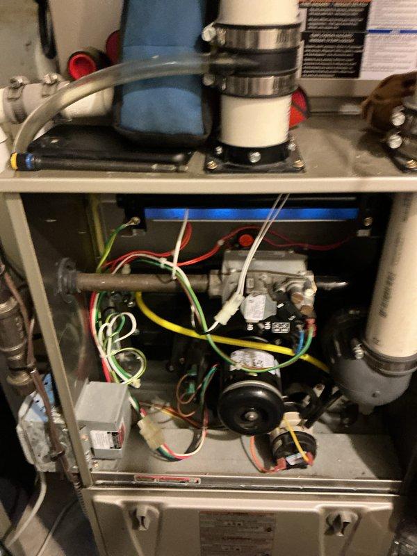 Performed scheduled maintenance on 12-year-old heating system. Inspected interior components including wiring connections, control boards, and PVC ventilation pipes. Noted significant dust accumulation on fan assembly blades requiring thorough cleaning to restore proper airflow and system efficiency.