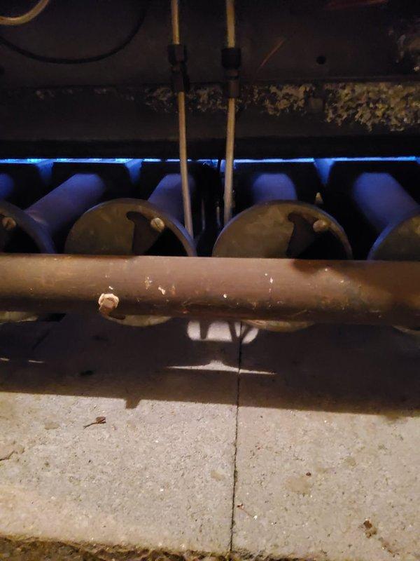 Responded to service call for intermittent heating issue on 30-year-old hot water boiler system. Inspection revealed significant corrosion and rust on pipe fittings at water heater connection points, indicating possible leakage. Examination of internal components showed aging copper pipes with valve deterioration and mineral buildup on heat exchanger elements, consistent with the system's advanced age.