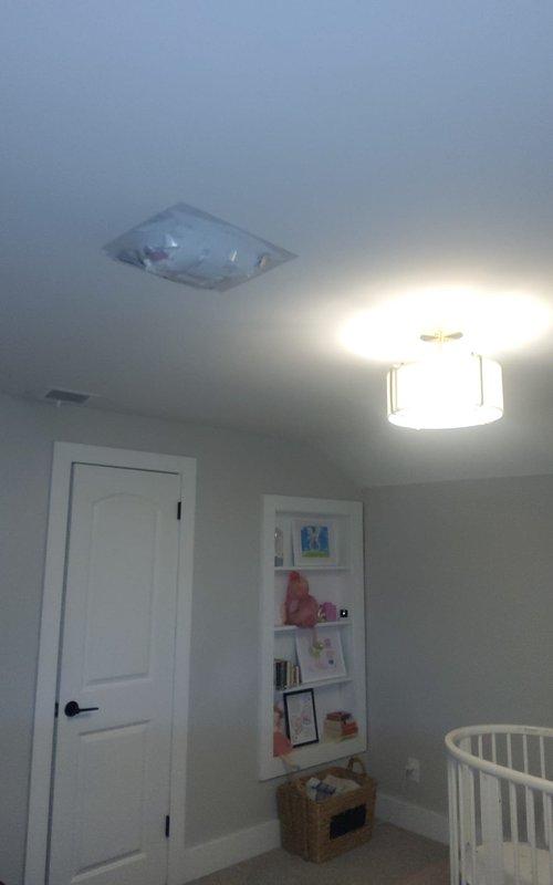 Inspected attic ductwork and identified multiple holes in the ducts allowing external debris infiltration. Documented damaged sections with photos showing compromised insulation around the ductwork and an affected ceiling register/vent in what appears to be a residential room. Further repairs recommended to prevent continued contamination of the HVAC system.