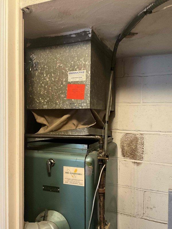 Conducted a comprehensive furnace replacement estimate on a 50+ year old heating system. Current installation features an aging blue-green furnace with visible wear and deterioration, connected to galvanized ductwork with existing PRODUCTIVE system labeling. Replacement recommendation will address the aged equipment, improve system efficiency, and ensure proper connection to existing gas lines and ductwork infrastructure.