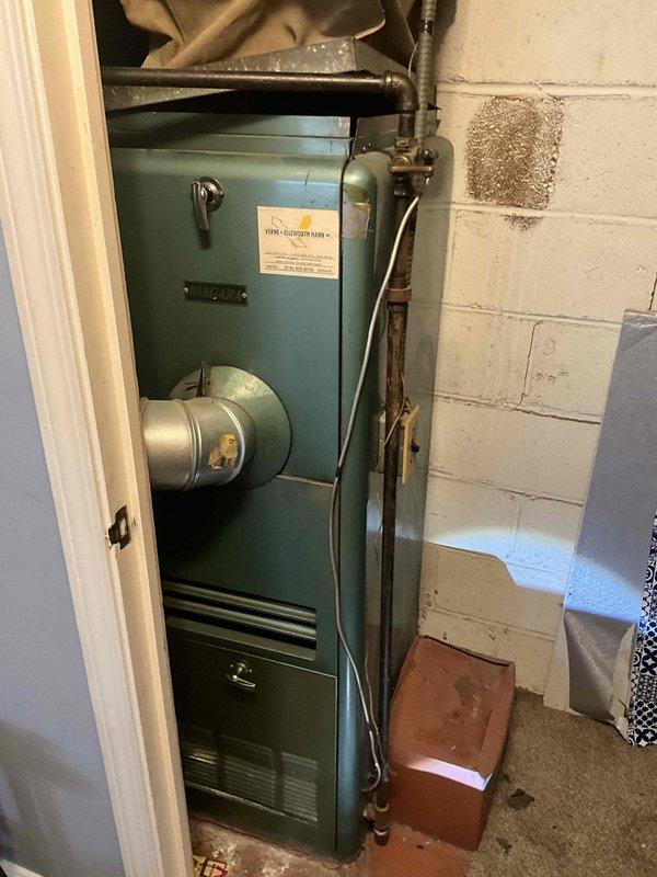 Conducted a comprehensive furnace replacement estimate on a 50+ year old heating system. Current installation features an aging blue-green furnace with visible wear and deterioration, connected to galvanized ductwork with existing PRODUCTIVE system labeling. Replacement recommendation will address the aged equipment, improve system efficiency, and ensure proper connection to existing gas lines and ductwork infrastructure.