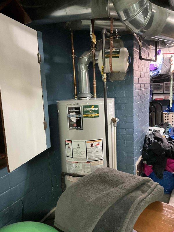 Completed inspection of 12-year-old AC system. Documented existing furnace unit with associated ductwork and water heater in basement utility area. System evaluation indicates replacement recommended due to age and condition of equipment.