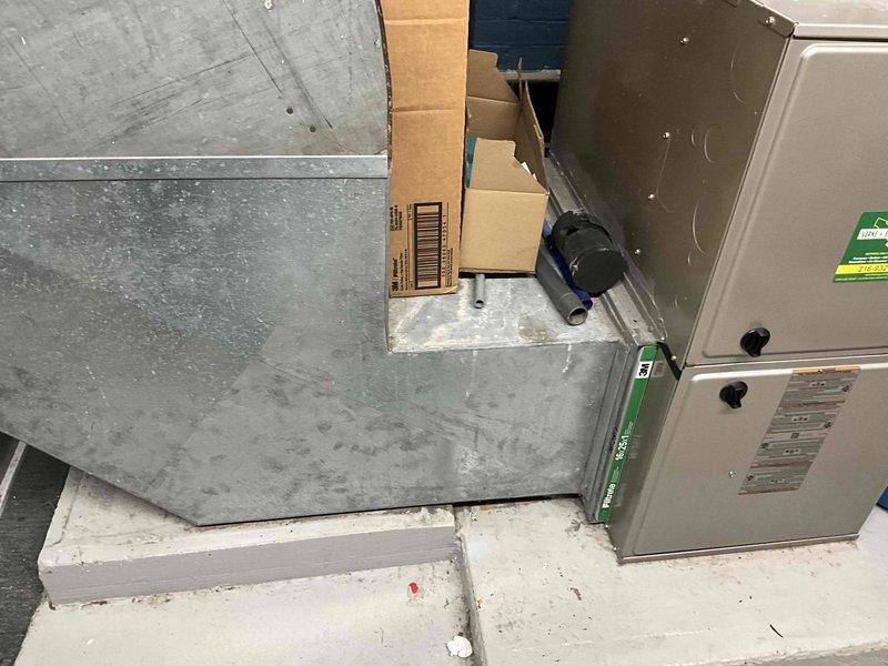 Completed inspection of 12-year-old AC system. Documented existing furnace unit with associated ductwork and water heater in basement utility area. System evaluation indicates replacement recommended due to age and condition of equipment.