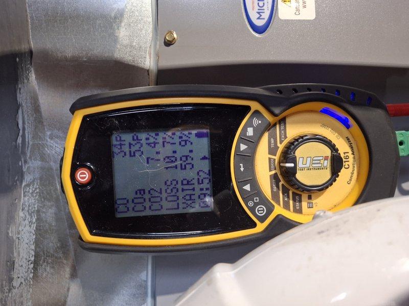 Performed scheduled Home Plan Heating Tune-Up on gas-fired steam boiler system. Inspected combustion chamber and verified proper blue flame pattern indicating efficient operation. Conducted comprehensive diagnostic testing using UEi C161 analyzer to measure temperature and pressure parameters, confirming all readings within manufacturer specifications.