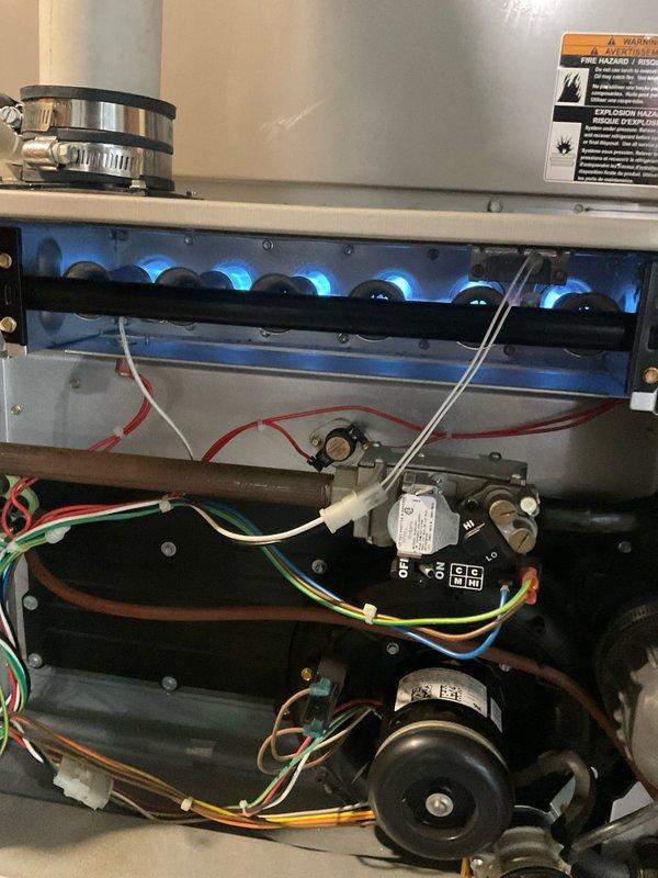 Performed furnace tune-up on 11-year-old system. Conducted temperature testing with digital probe thermometer, verifying readings at 62.7°F. Inspected burner assembly, confirming proper flame pattern and combustion. All electrical components, control board settings, and wiring connections were checked and confirmed to be in good working condition.