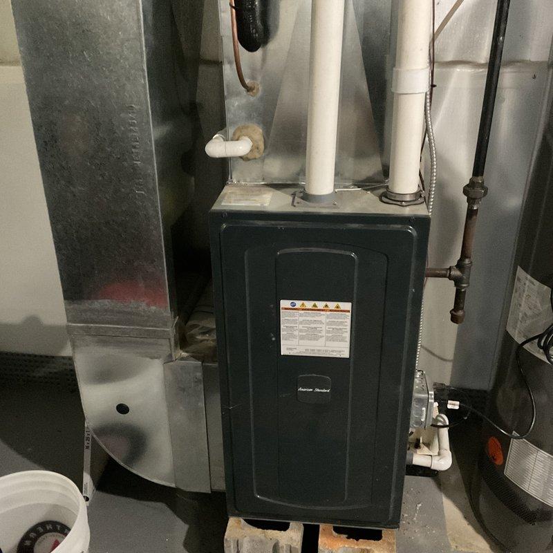 Responded to service call for AC system with damaged condenser unit caused by fallen frozen gutters. Performed diagnostic assessment of the outdoor condenser and inspected interior furnace components for related damage. System was approximately 5+ years old; documented current condition with photos of both exterior unit and indoor components for service records.