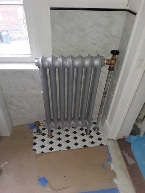 Successfully completed reinstallation of four steam radiators, including replacement of all valves and traps. Work performed by two technicians over 5-6 hours with proper floor protection in place during the renovation process.