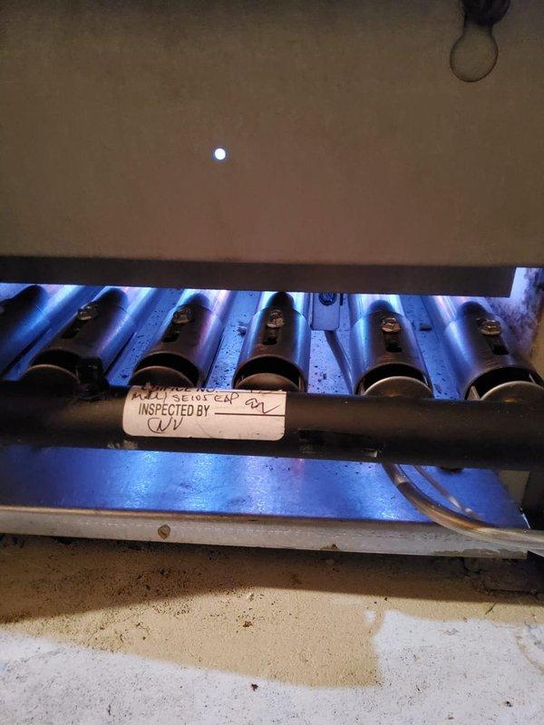 Performed scheduled boiler tune-up service, inspecting all internal components. Observed significant rust and oxidation on the heat exchanger tubes and central divider. Documented condition of burner tubes and verified proper operation of the heating system.