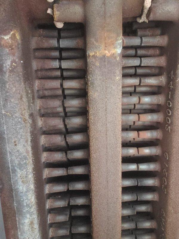 Performed scheduled boiler tune-up service, inspecting all internal components. Observed significant rust and oxidation on the heat exchanger tubes and central divider. Documented condition of burner tubes and verified proper operation of the heating system.